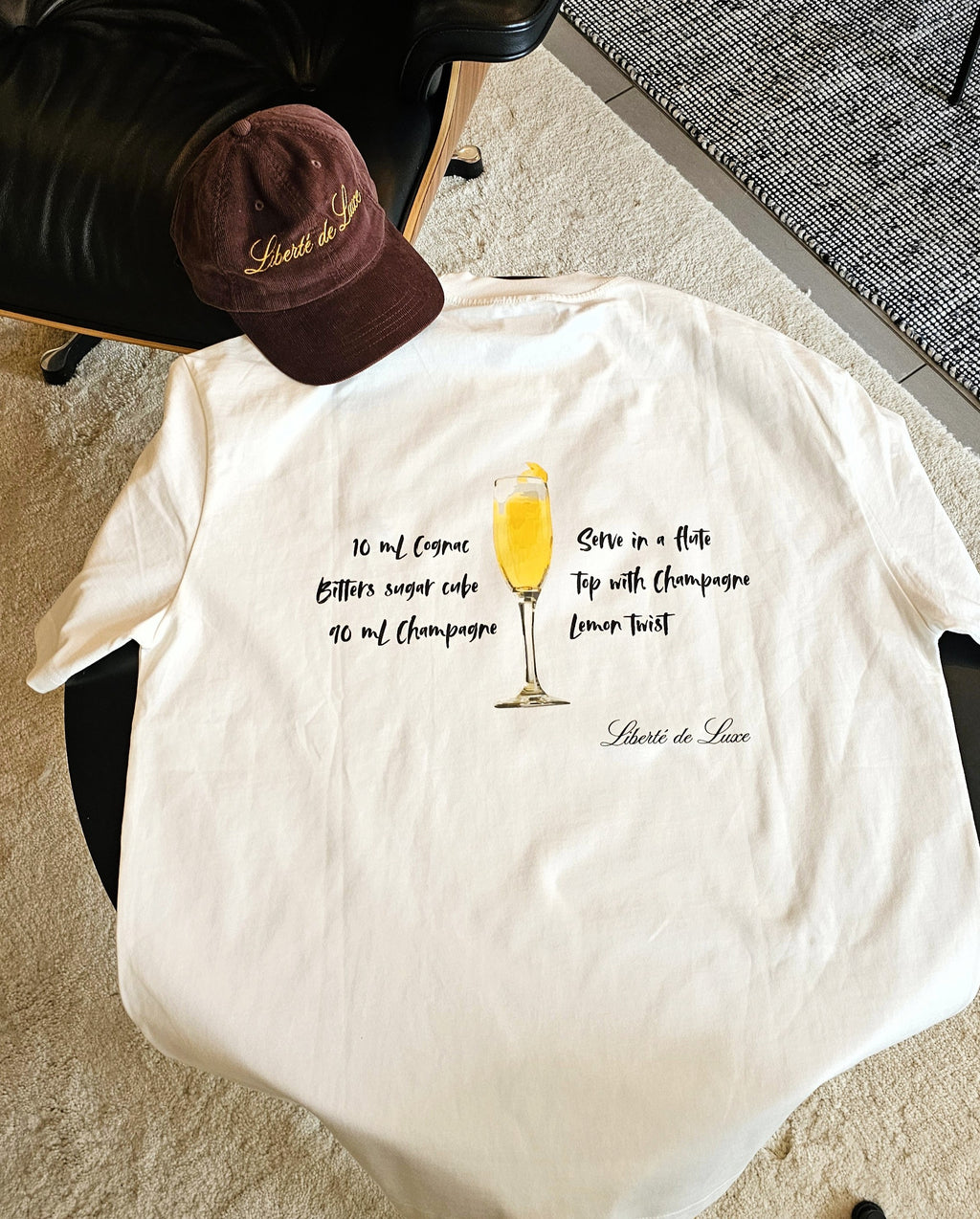 White t-shirt with cocktail recipe graphic on a chair